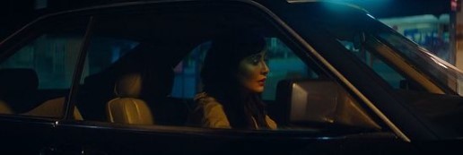 a woman sitting in a car at night