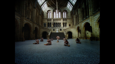 a group of people sitting on the ground in a building