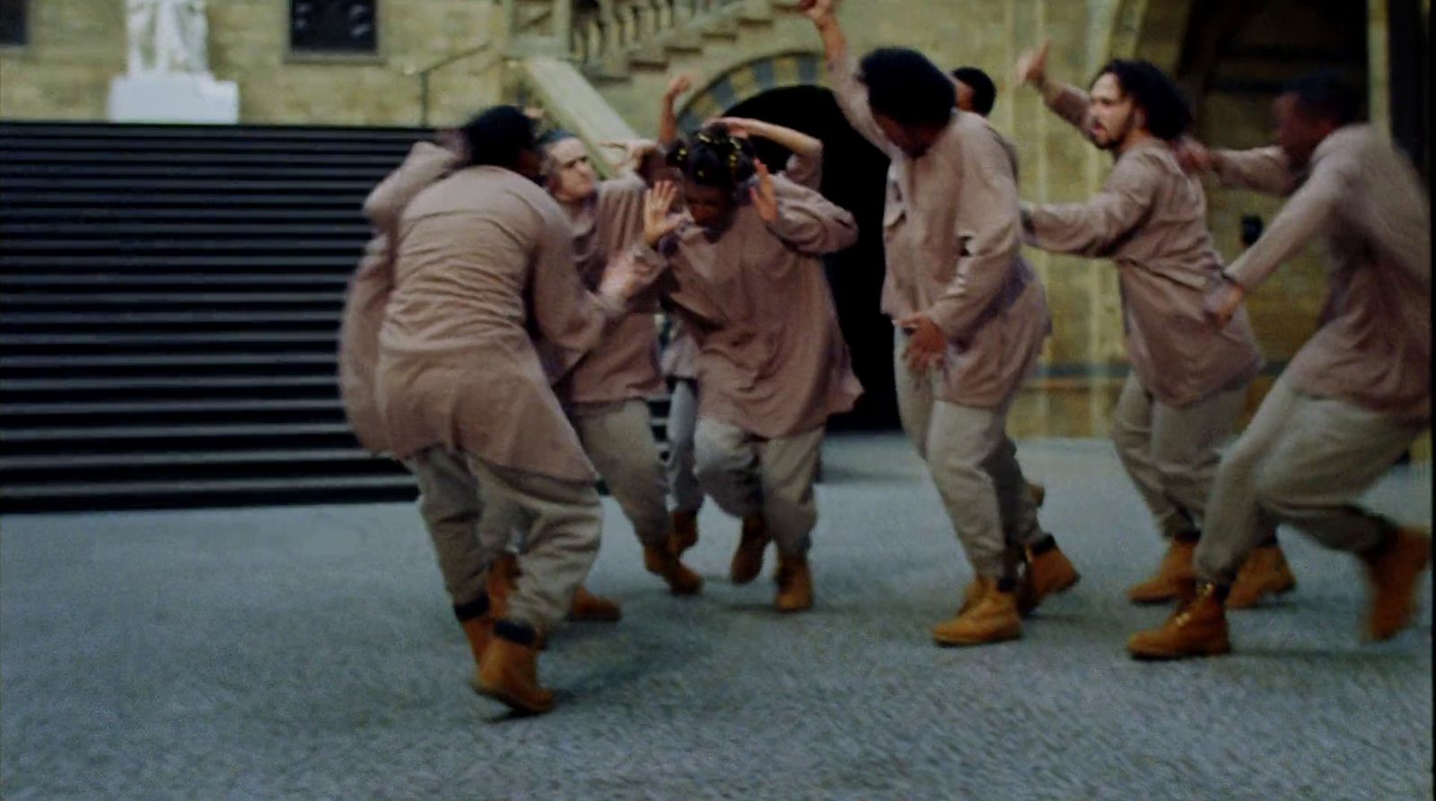 a group of people dancing in front of a building