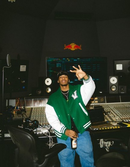 a man standing in front of a mixing desk