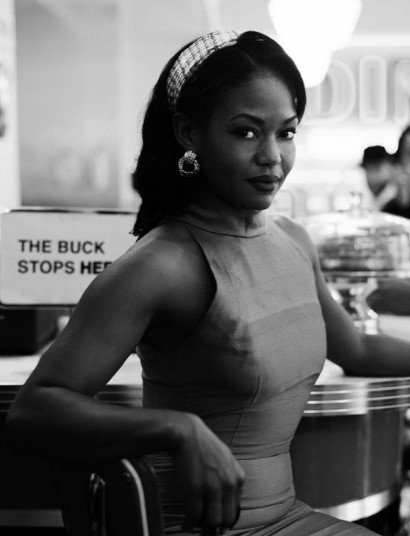 a woman in a dress sitting at a counter