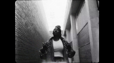 a woman walking down a narrow alley way