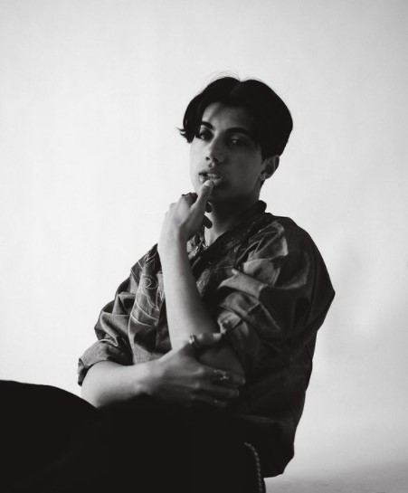 a black and white photo of a man smoking a cigarette