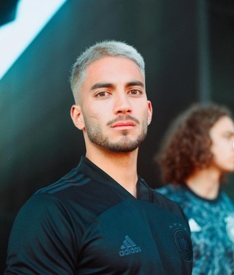 a man in a black shirt standing next to another man