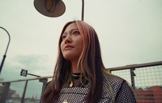 a woman standing in front of a street light