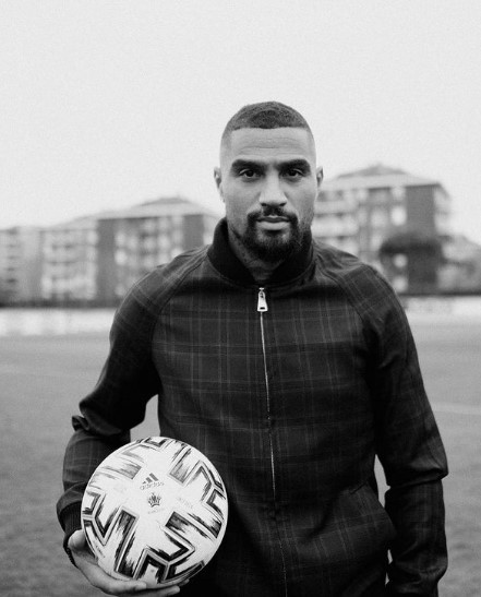 a man holding a soccer ball on a field