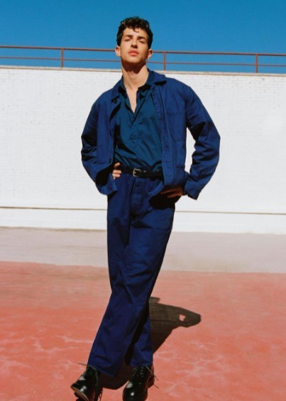 a man standing in front of a white wall