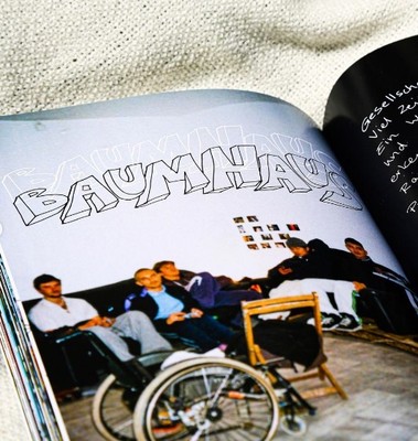 a book with a picture of a group of men sitting on a bench