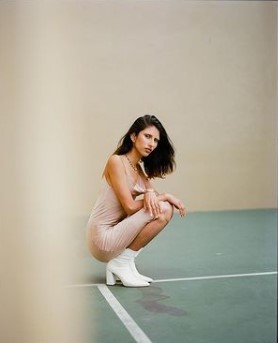 a woman kneeling down on a tennis court