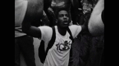 a young man holding a basketball in his hands