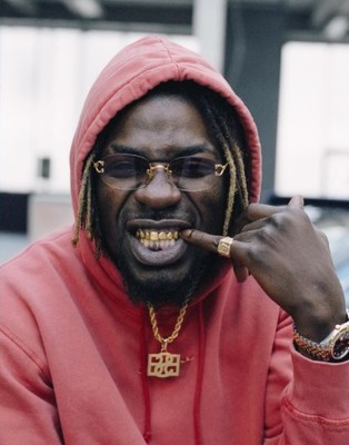 a man in a red hoodie smoking a cigarette