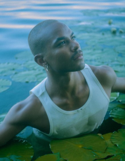 a man sitting in the water with his arms crossed