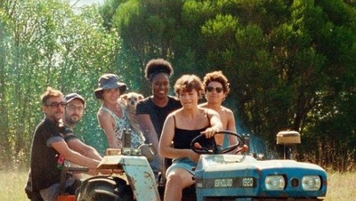 a group of people riding on the back of an atv