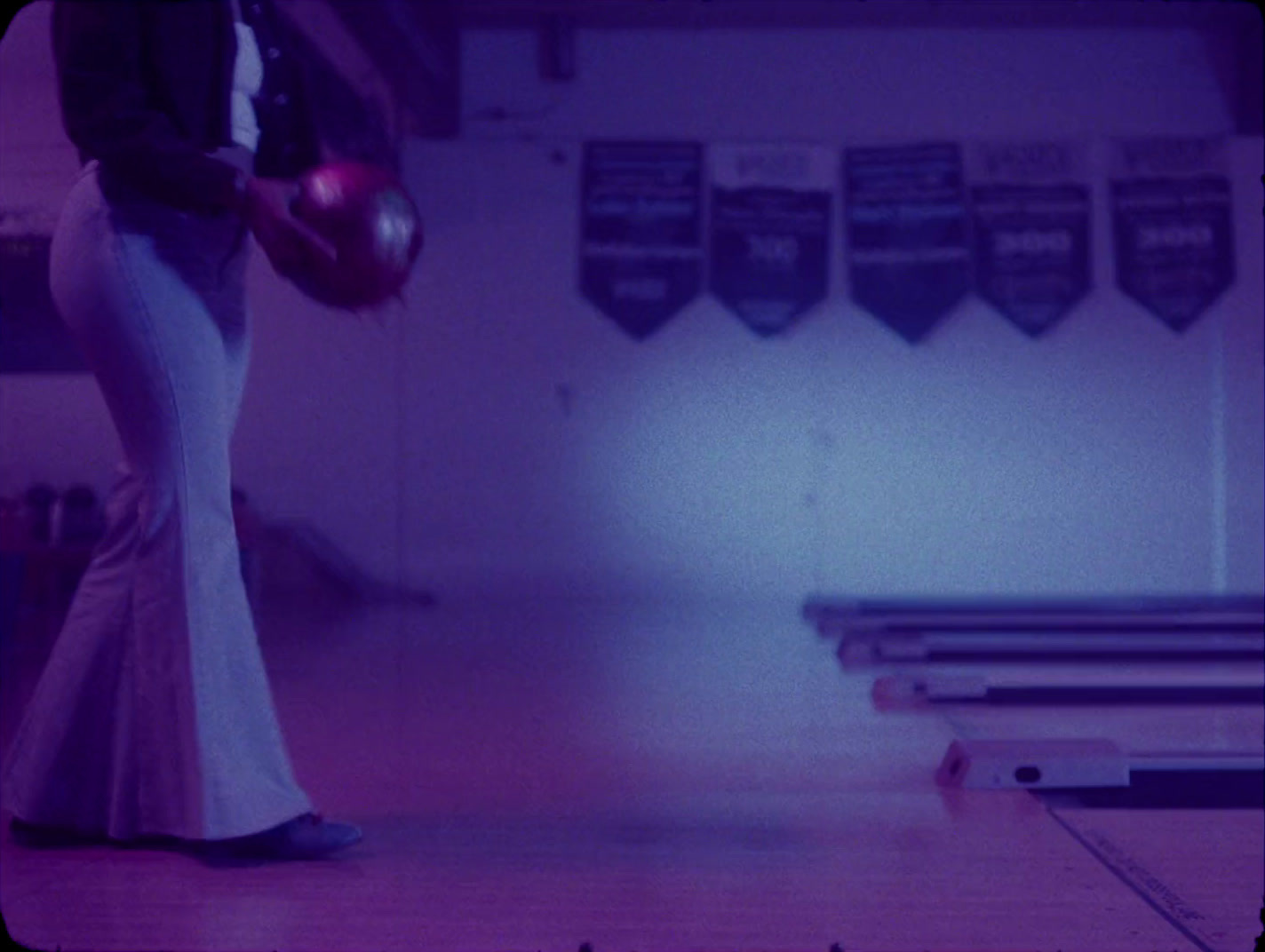 a woman in a long dress holding a bowling ball