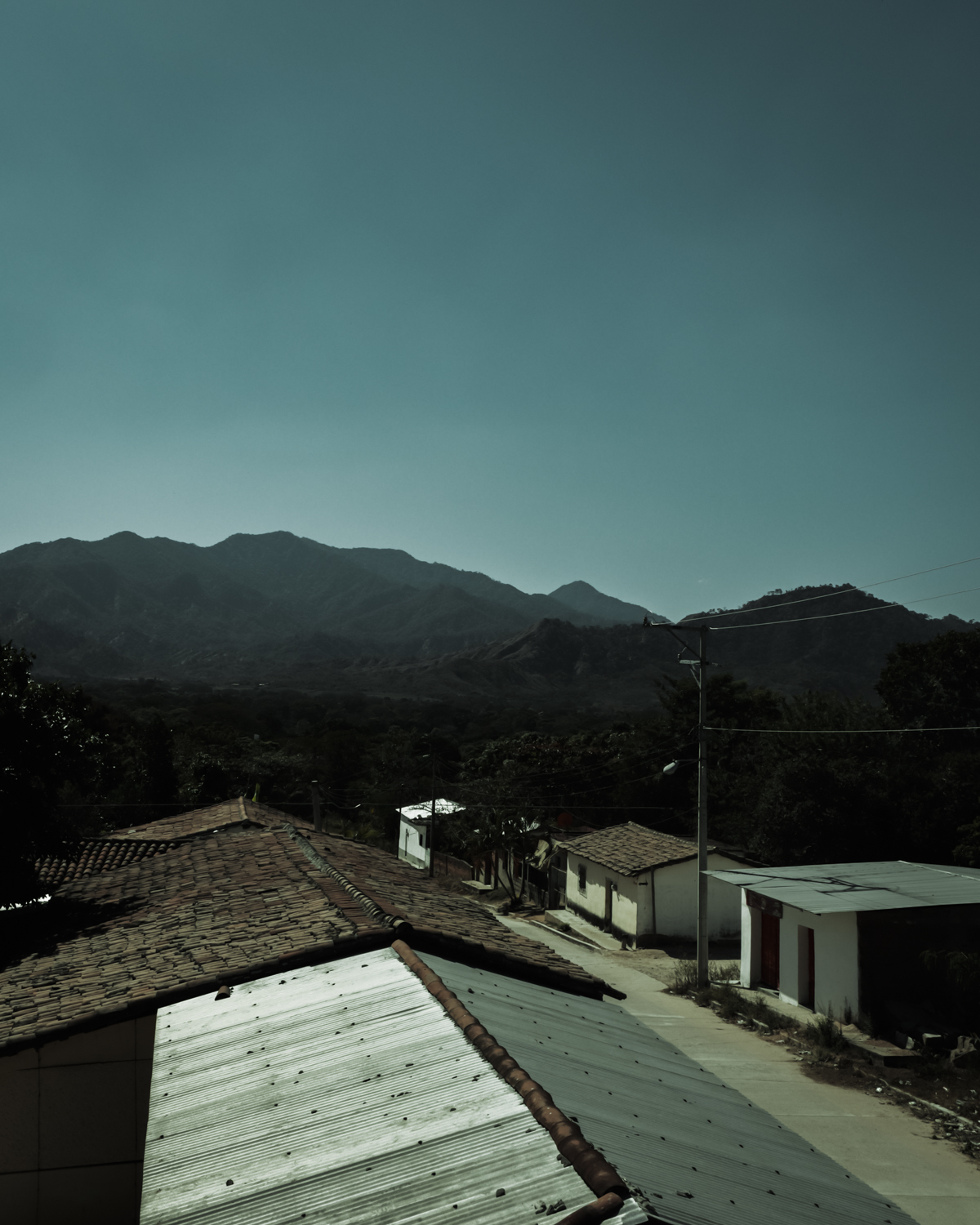 a view of a mountain range from a rooftop