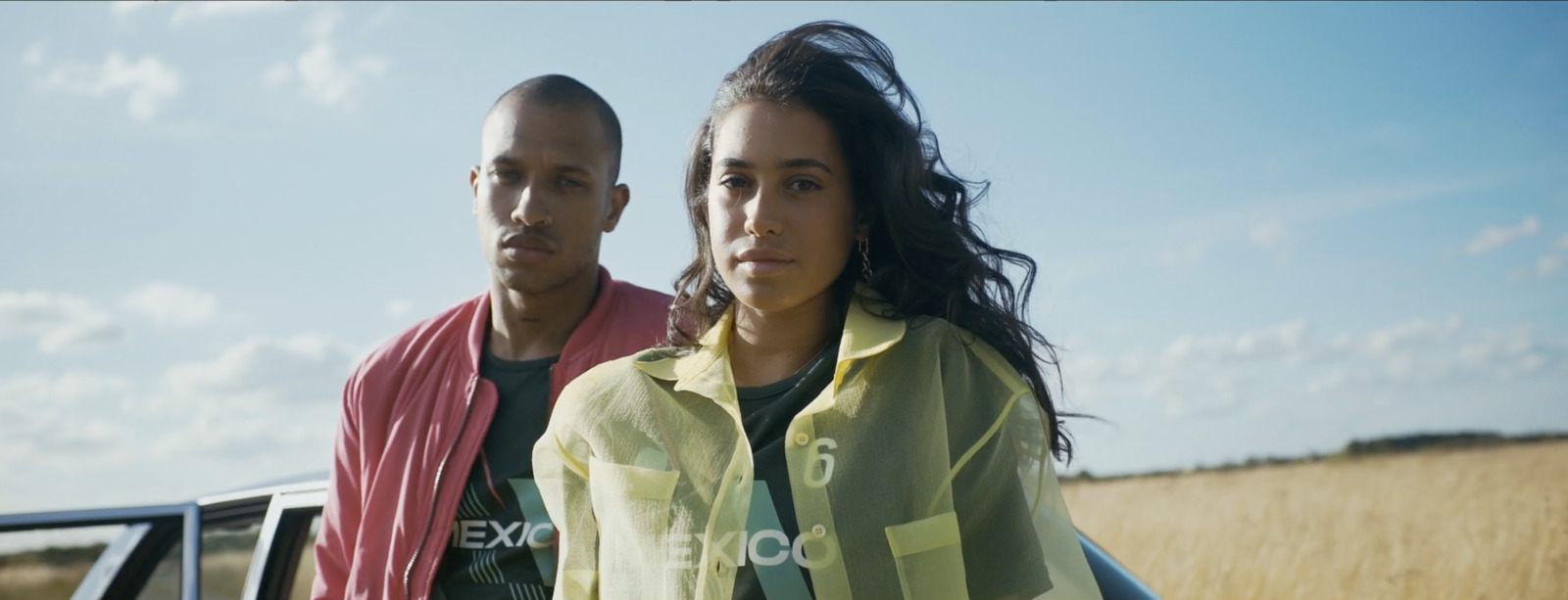 a man and a woman standing in front of a truck