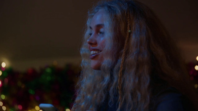 a woman with long hair looking at her cell phone