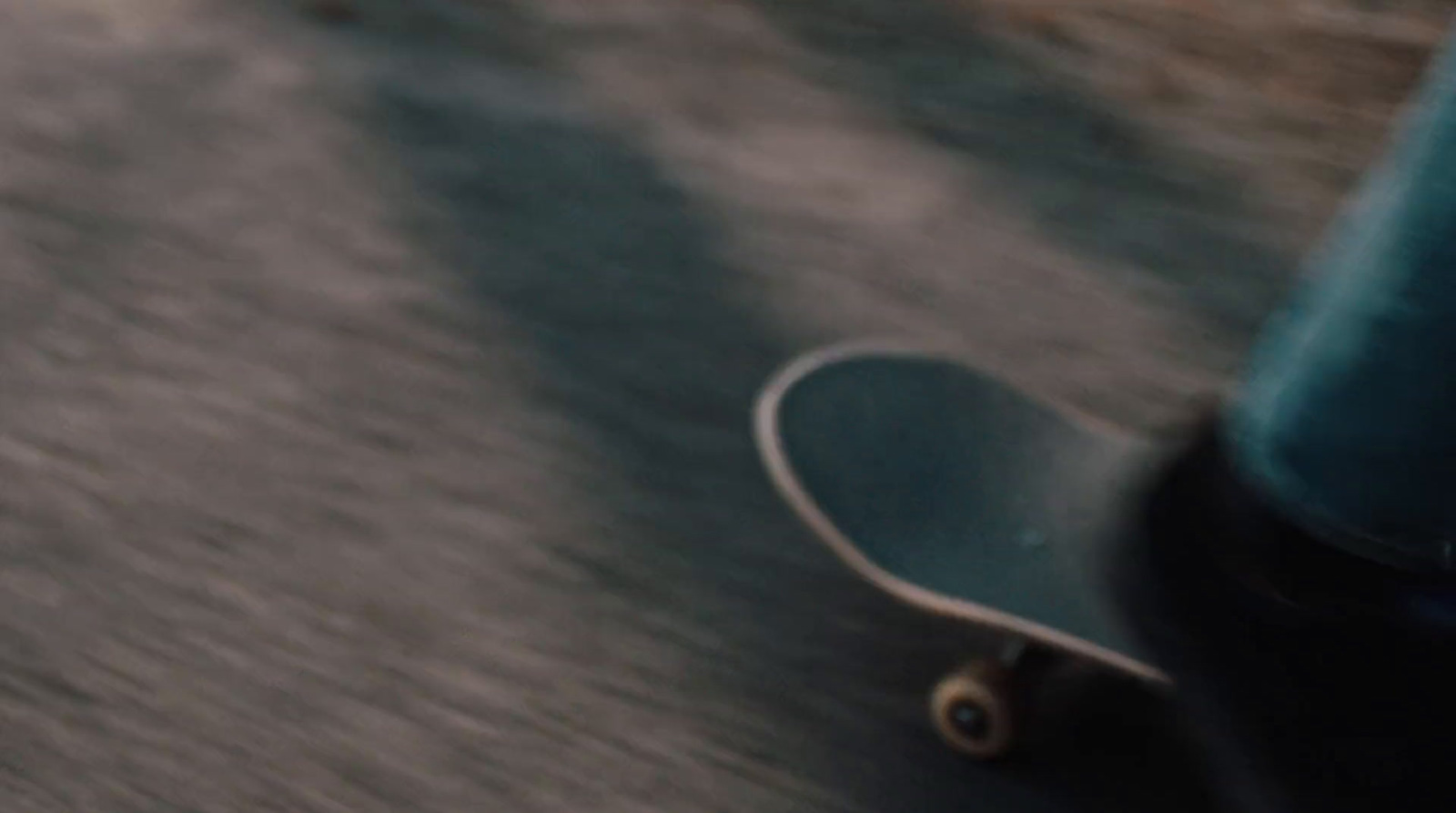 a person riding a skateboard down a street