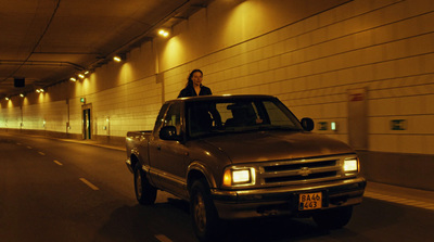 a woman standing on the hood of a truck