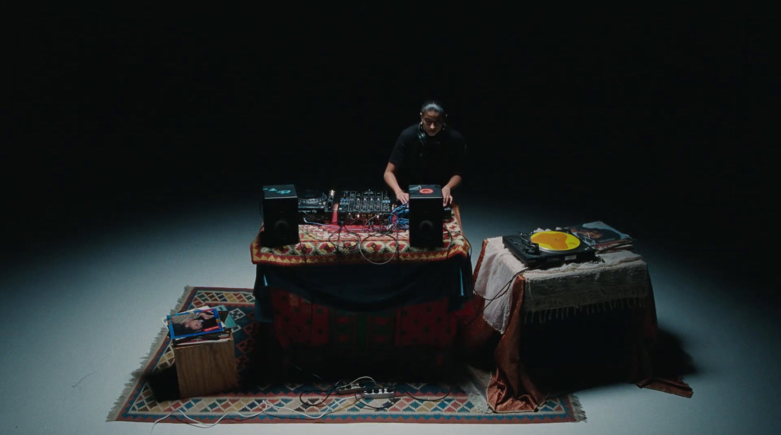 a man standing next to a table with a laptop on it