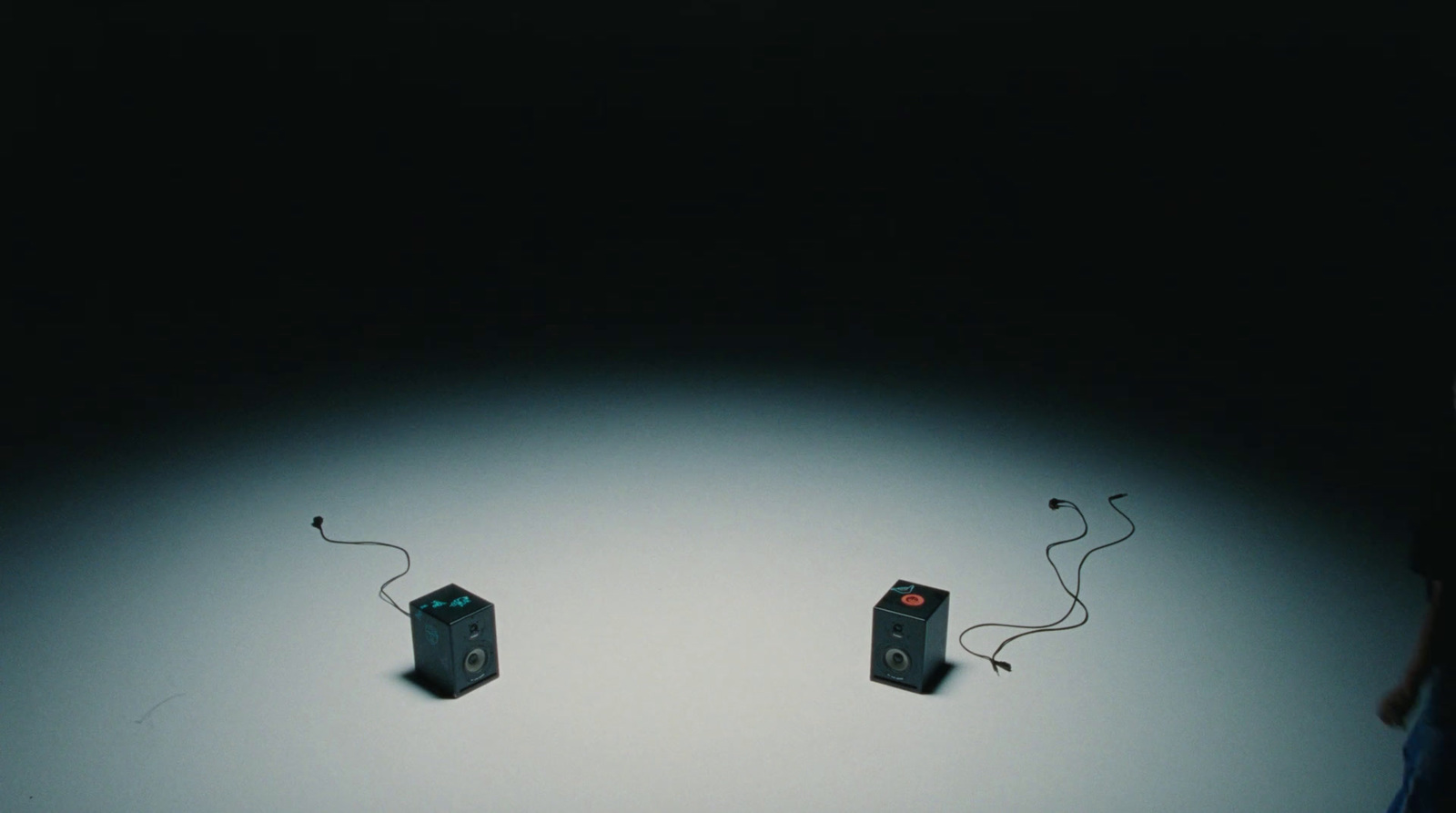 a couple of speakers sitting on top of a table