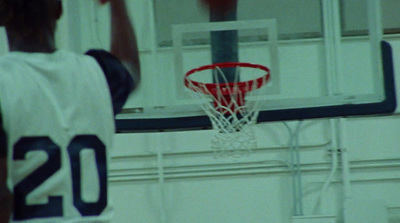 a basketball player dunking a basketball into the hoop