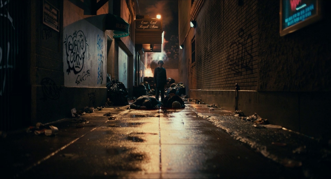 a person walking down a street at night