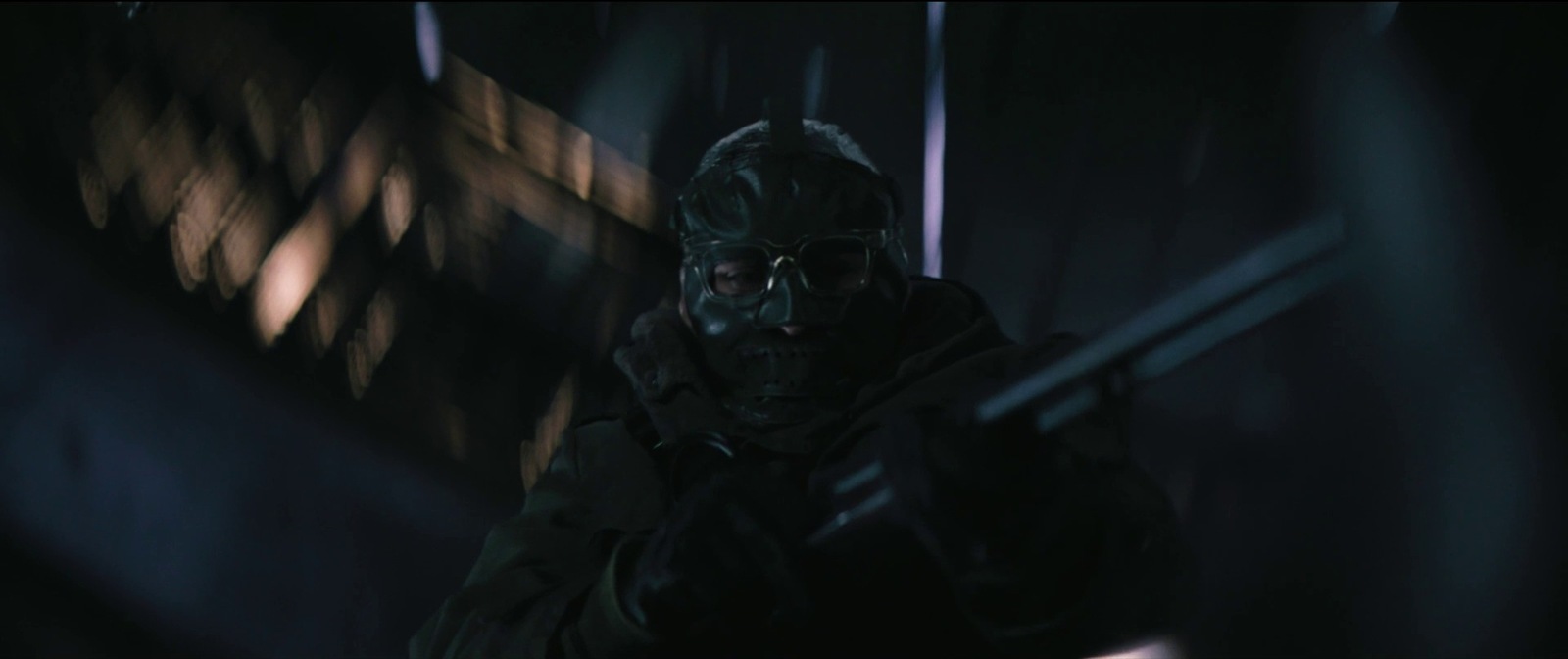 a man in a gas mask and goggles in a dark room