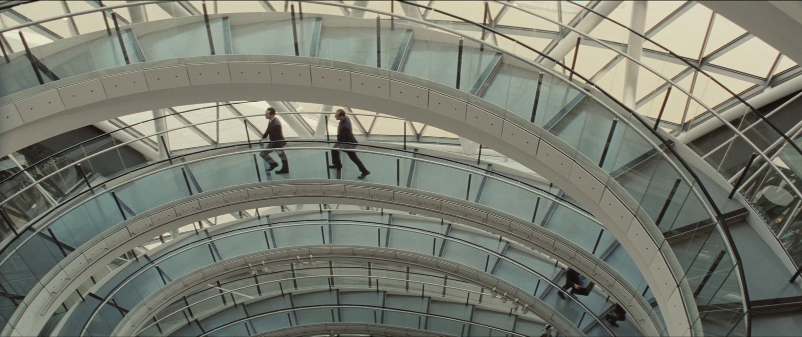 a group of people walking up and down a glass walkway