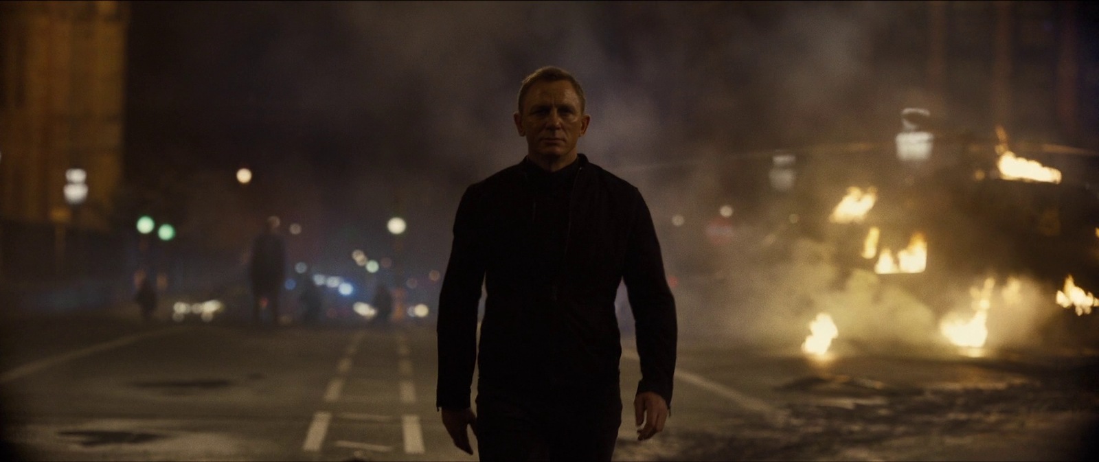 a man standing in the middle of a street at night