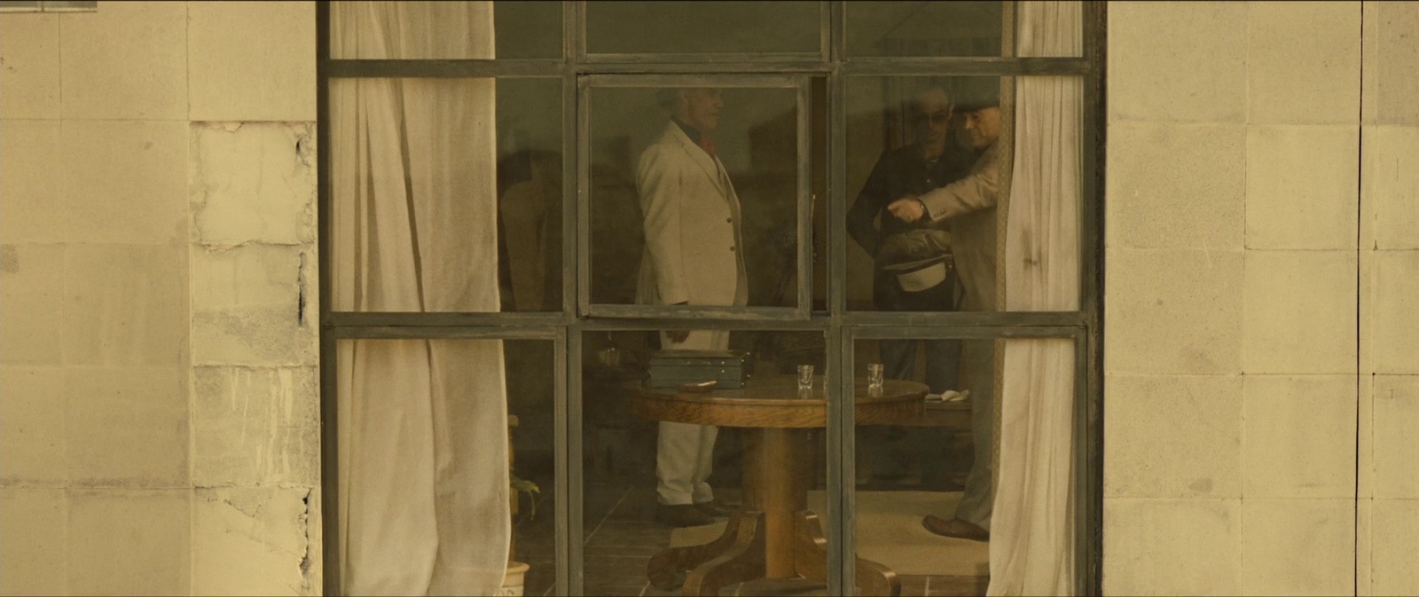 a couple of men standing outside of a window