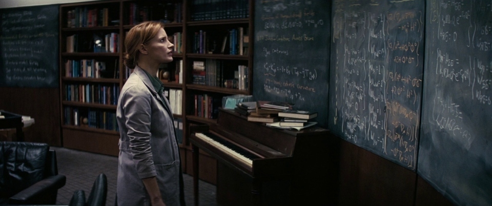 a woman standing in front of a piano in a library