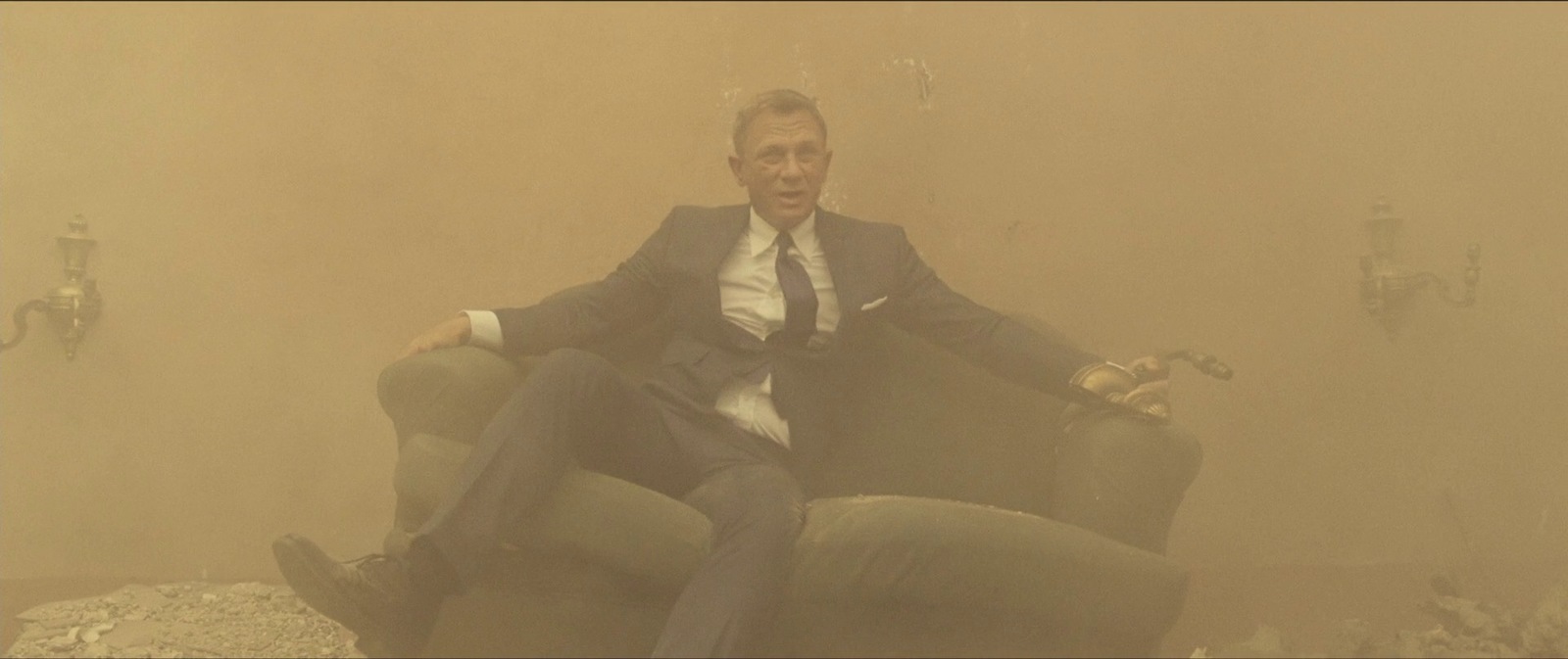 a man in a suit sitting on a chair