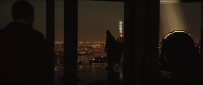 a person standing in front of a window at night