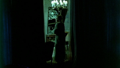 a person standing in front of a mirror in a dark room