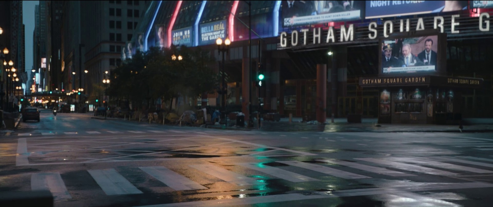 a city street at night with a green traffic light