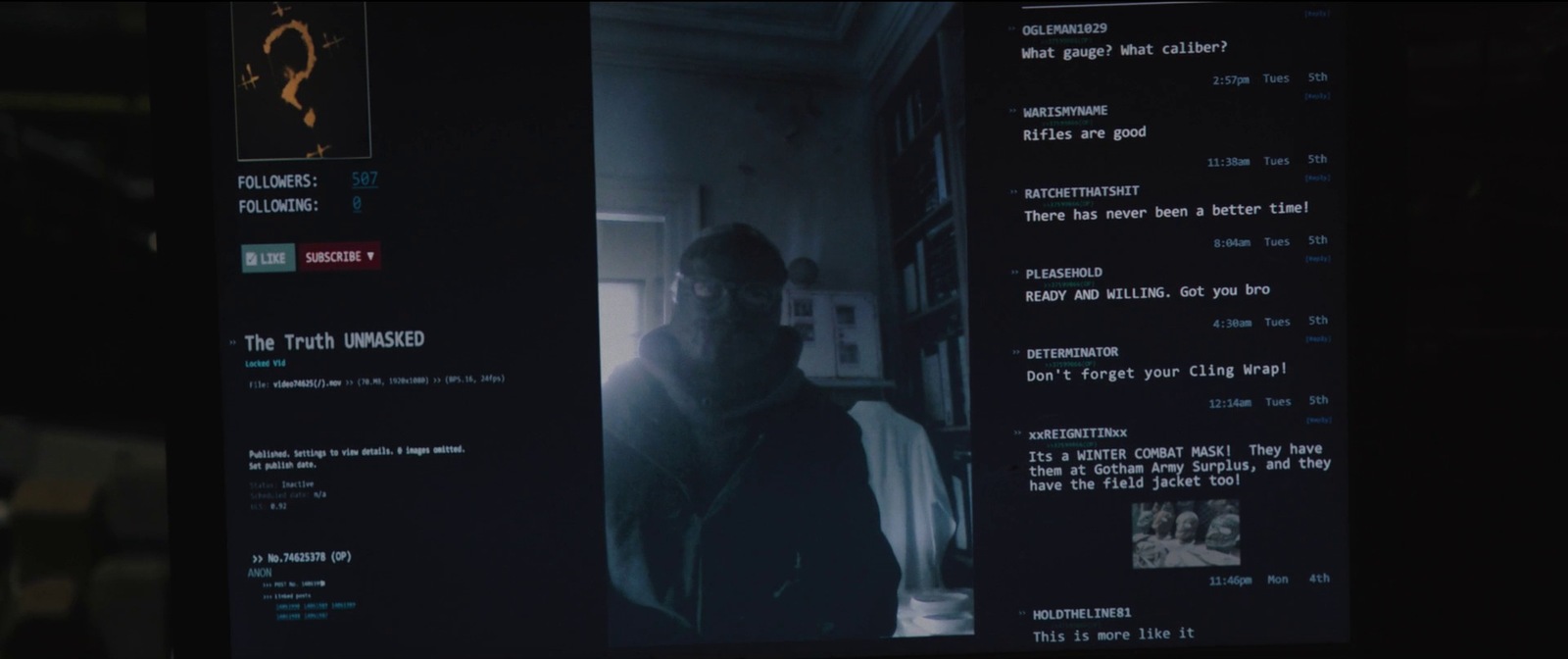 a man standing in front of a screen in a dark room