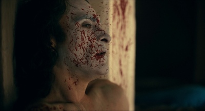 a woman with blood all over her face