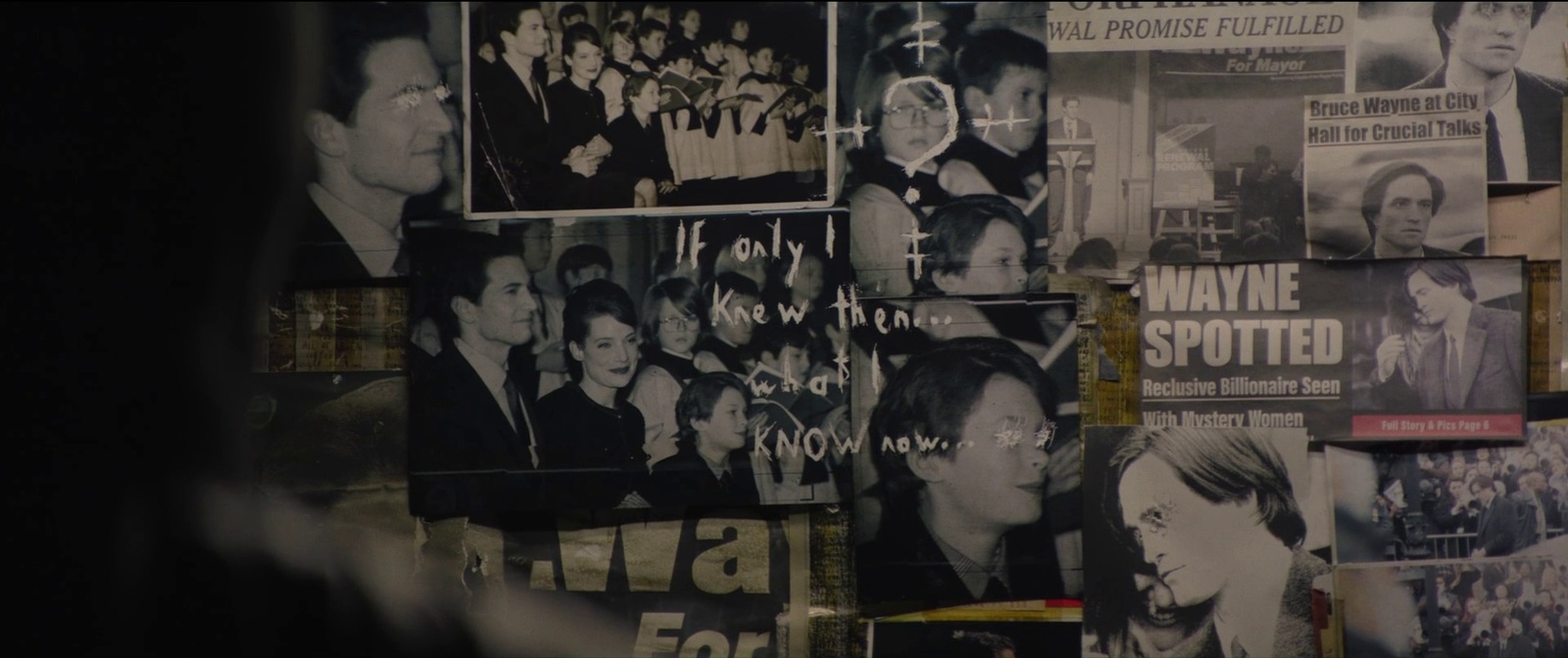 a wall covered in posters and pictures of people