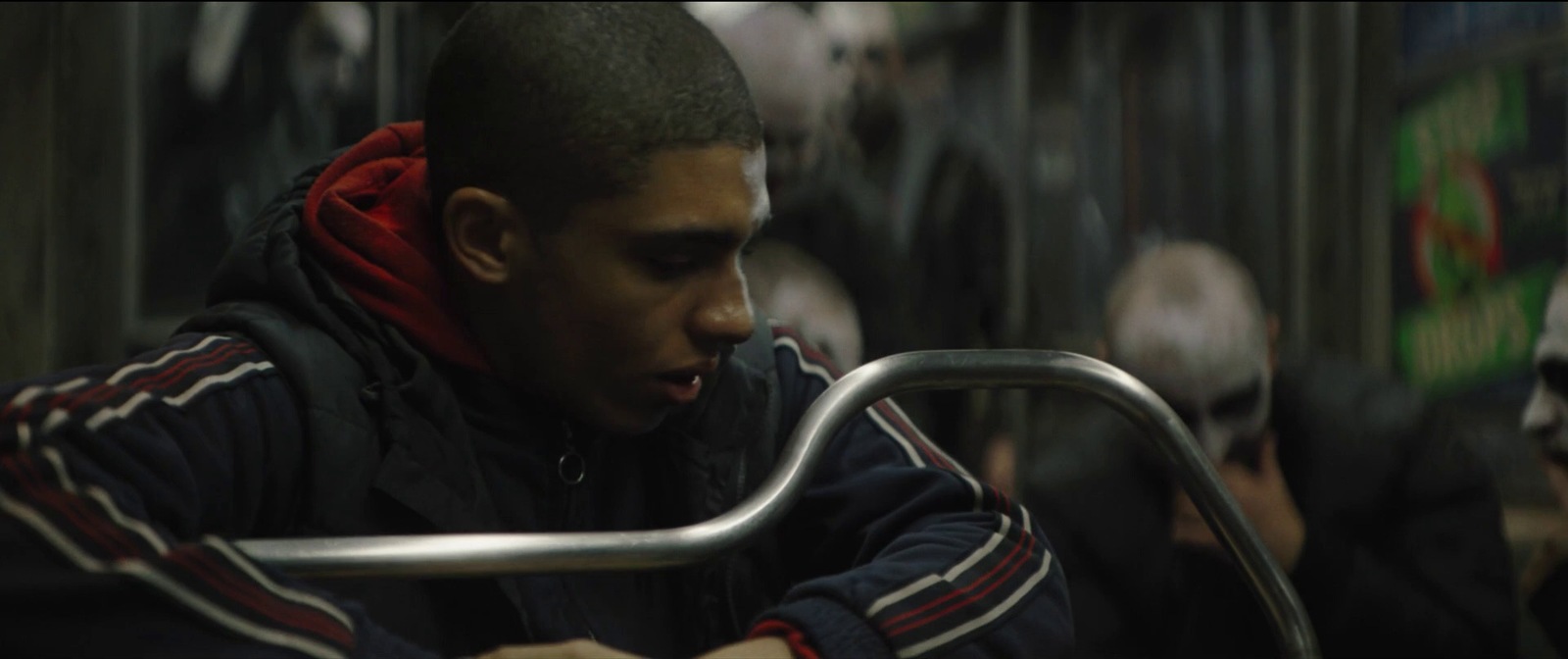 a man sitting on a bus with his hand on the handlebar