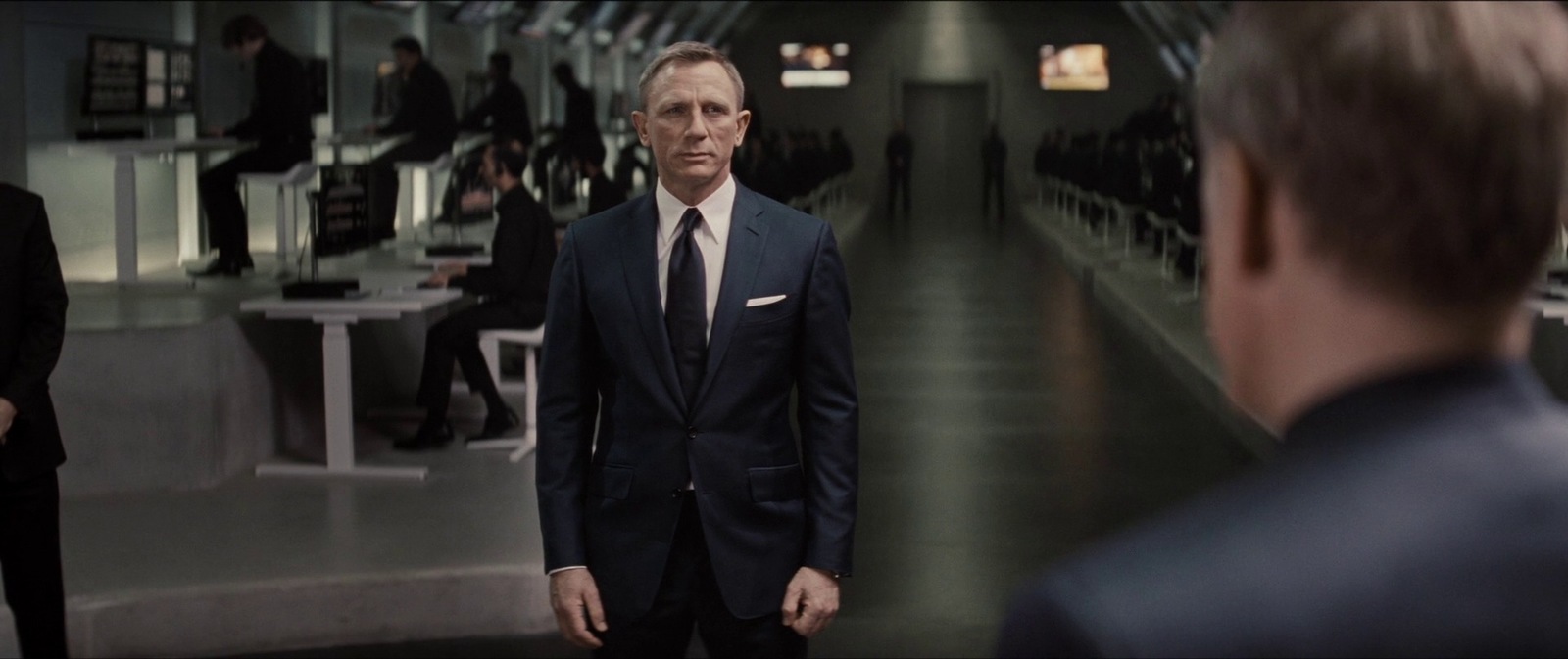 a man in a suit and tie standing in a hallway