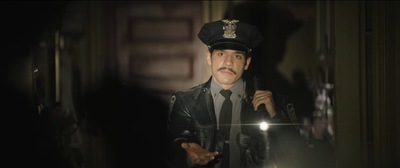 a man in a police uniform standing in a hallway