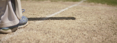 a close up of a person's shoes on a field