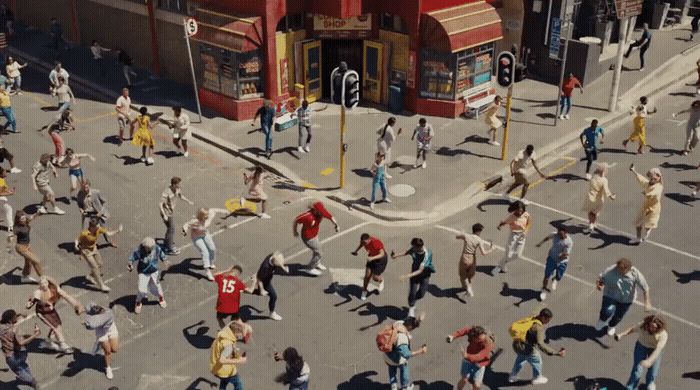 a large group of people walking across a street