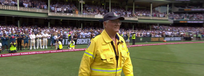 a man in a fireman's uniform standing in front of a crowd