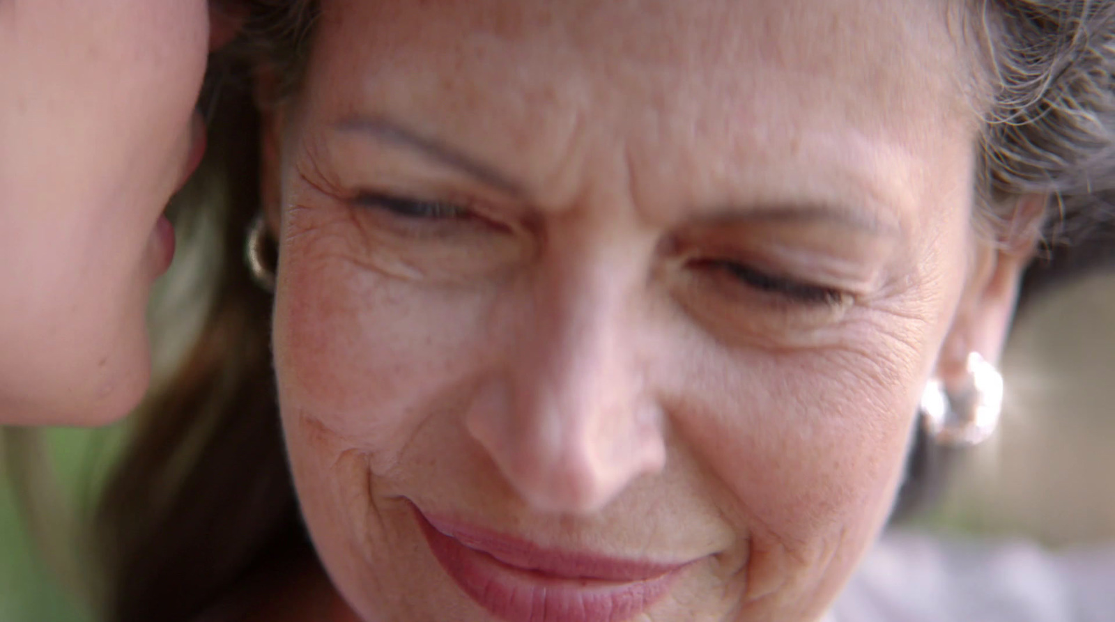 a close up of a woman looking at a cell phone