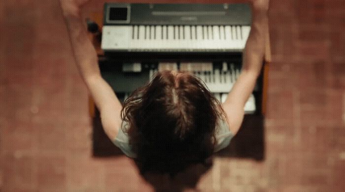 a woman standing in front of a keyboard