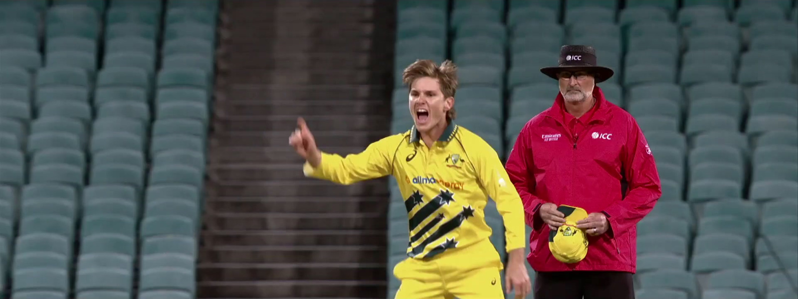 a man in a yellow uniform standing next to a man in a red shirt