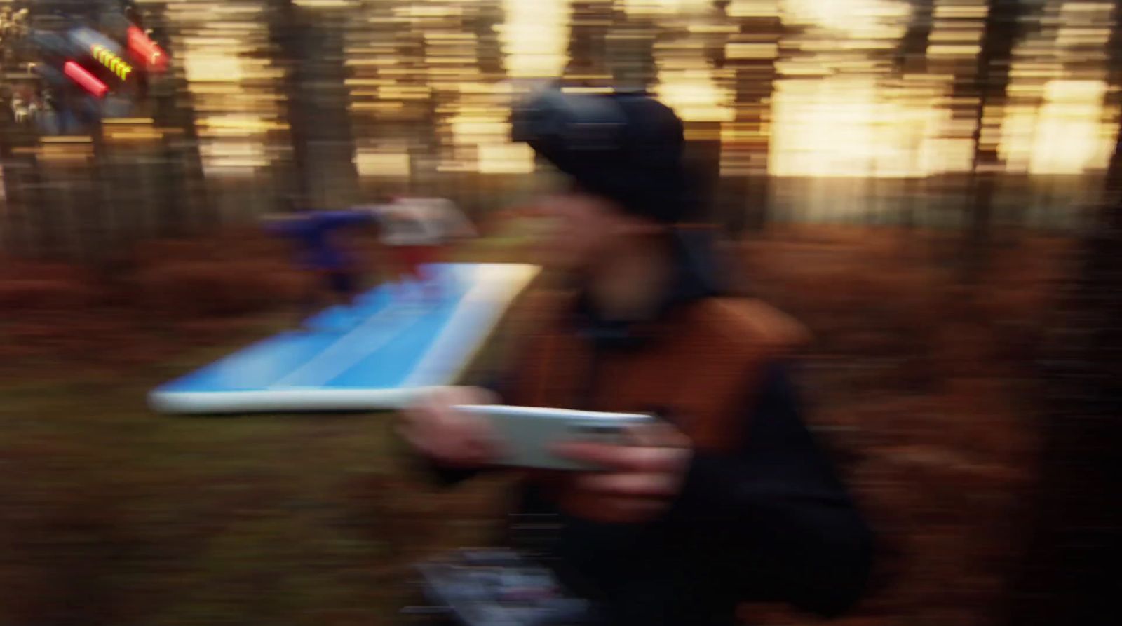 a blurry photo of a person holding a remote control