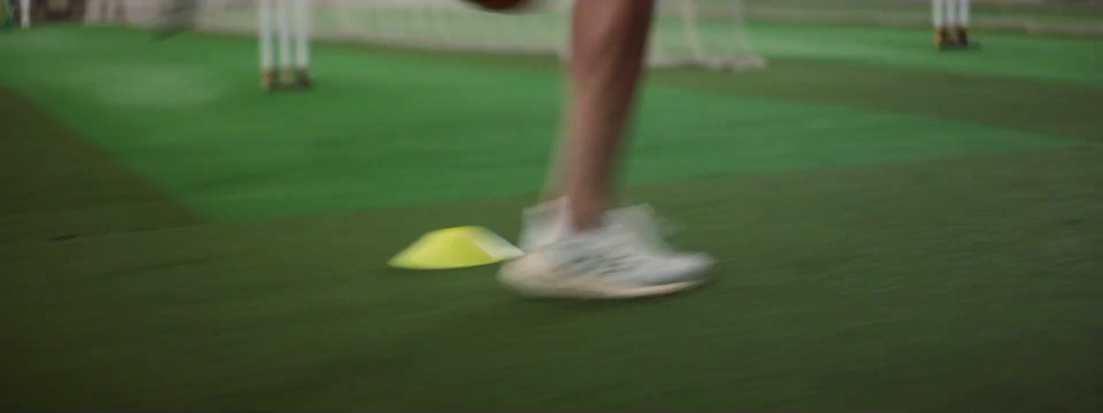 a blurry photo of a person kicking a ball